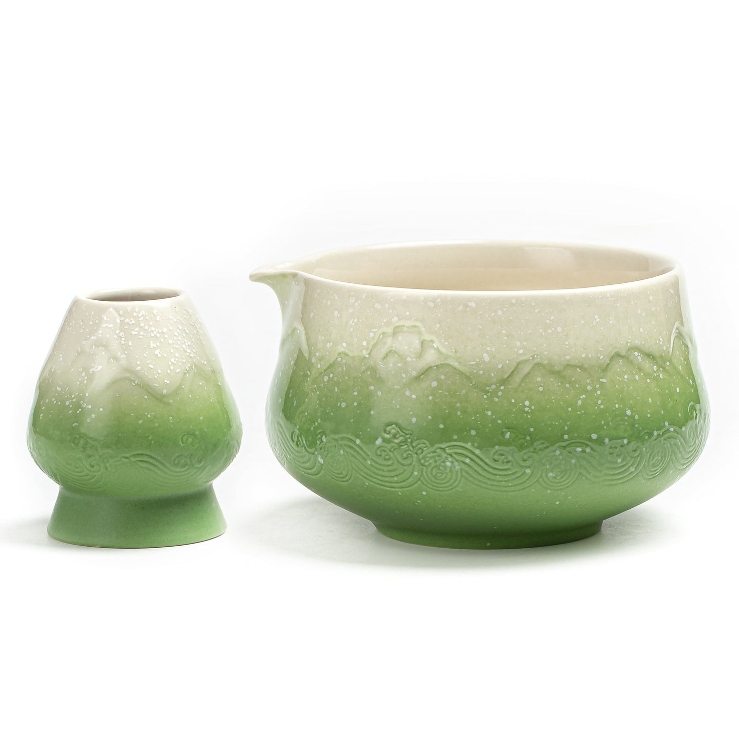 Green ceramic teapot with lid on a white background