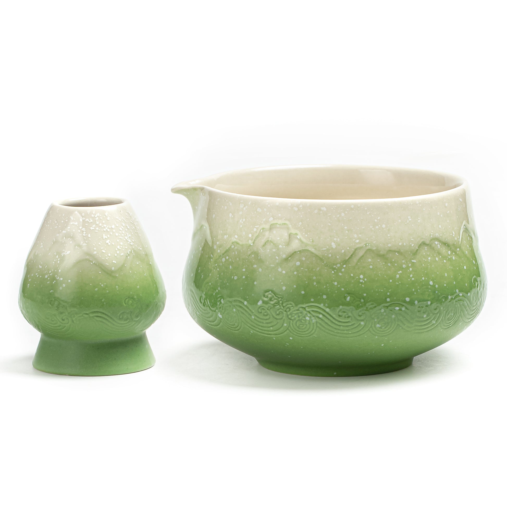 Green ceramic teapot with lid on a white background