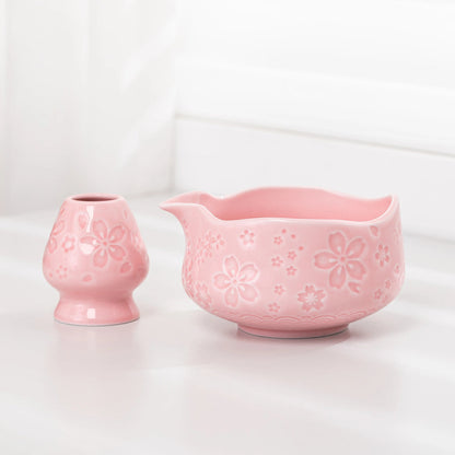Two pink ceramic items with floral patterns on a white background